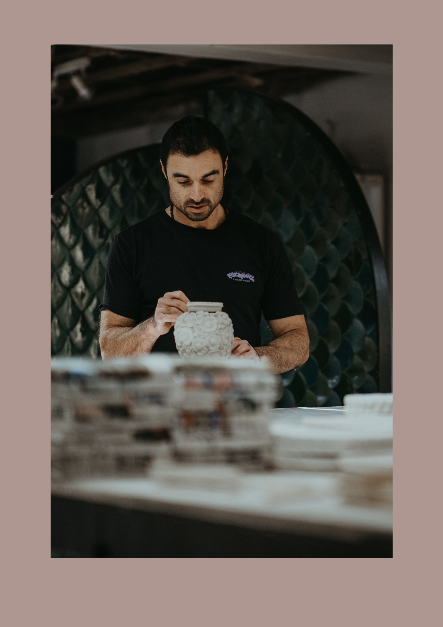 Skilled ceramic artisan hand-finishing a handcrafted ceramic vessel in the Akashic Tiles workshop, showcasing traditional craftsmanship and bespoke ceramic design.