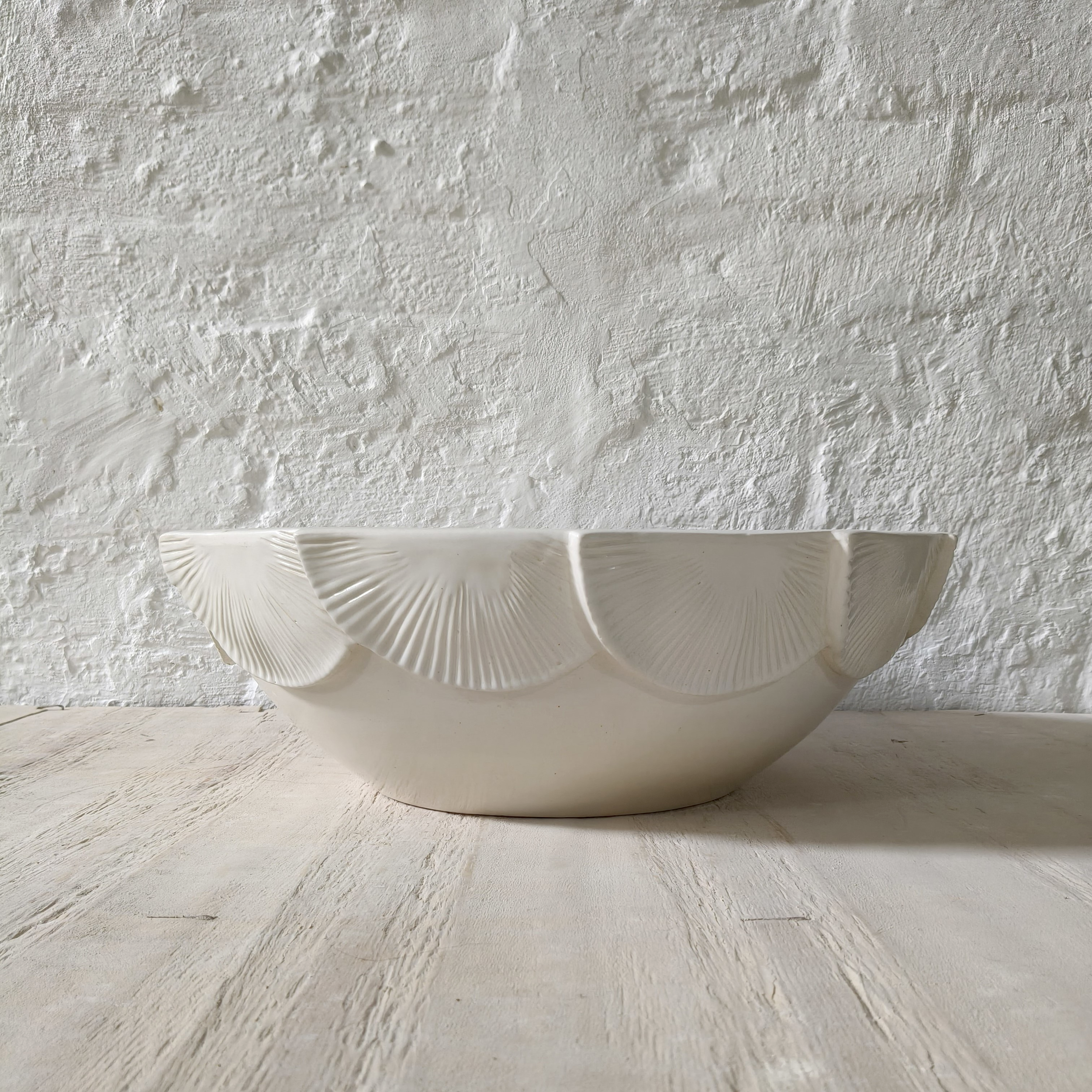 Decorative white ceramic bathroom basin featuring handcrafted fan-shaped relief patterns and a contemporary organic silhouette.
